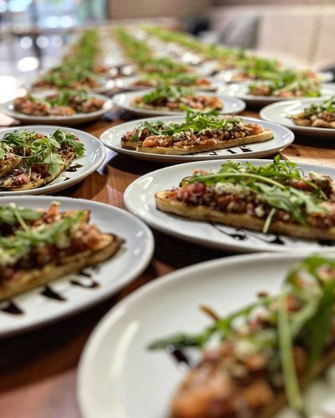 A Row of Plates of Food Are Sitting on A Table — Roundabout Inn in Gloucester, NSW