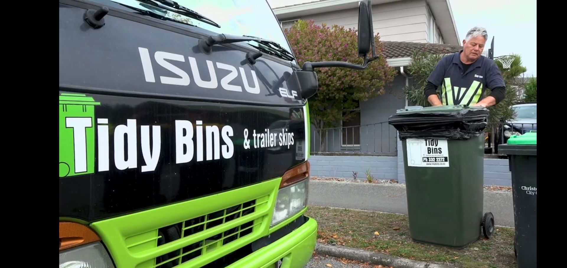 One of the Tidy Bins drivers with a wheelie bin trash during a regular collection route.