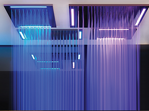 Modern shower with blue and purple LED lights illuminating streams of water.