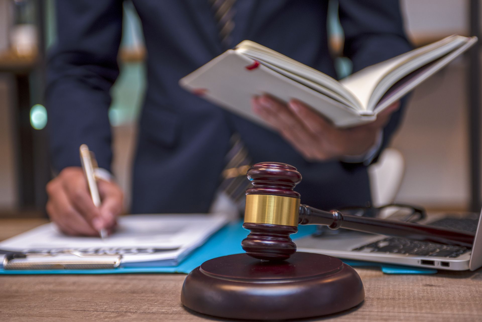 A woman is crawling on the ice on the side of the road.