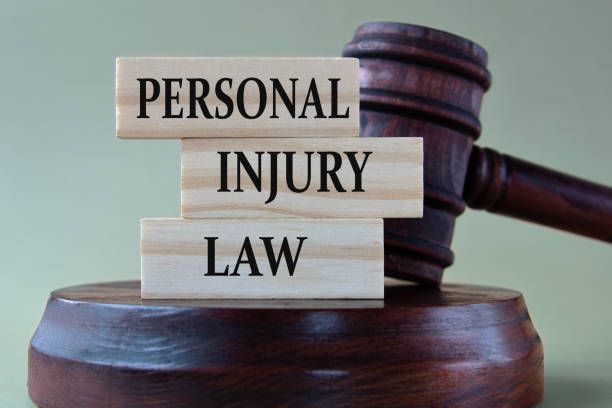 Personal Injury Law: words on wooden blocks against the background of a judge's gavel with a stand.