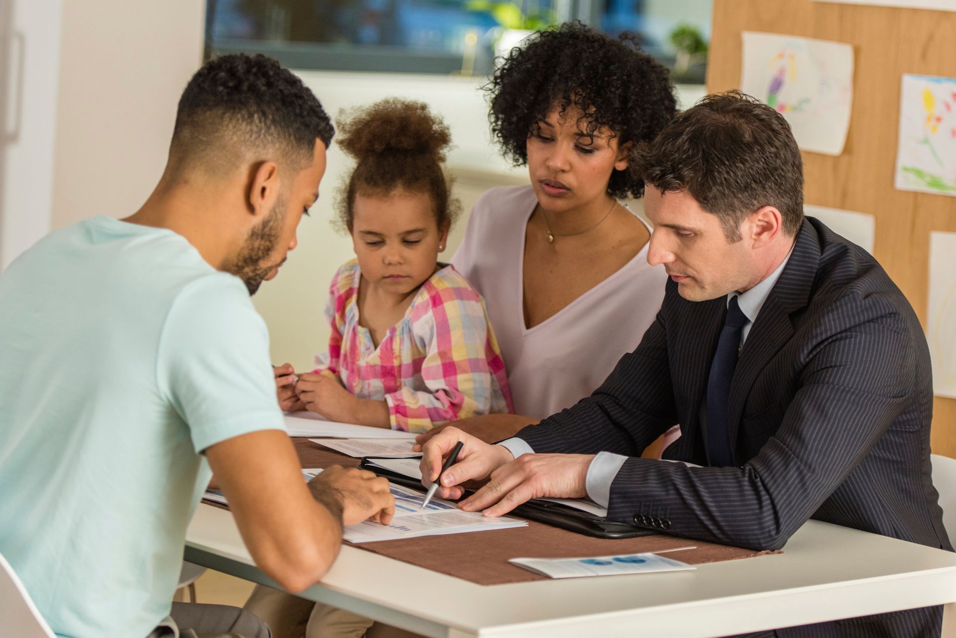 Family with child consulting a family law attorney at a desk for legal advice and support.