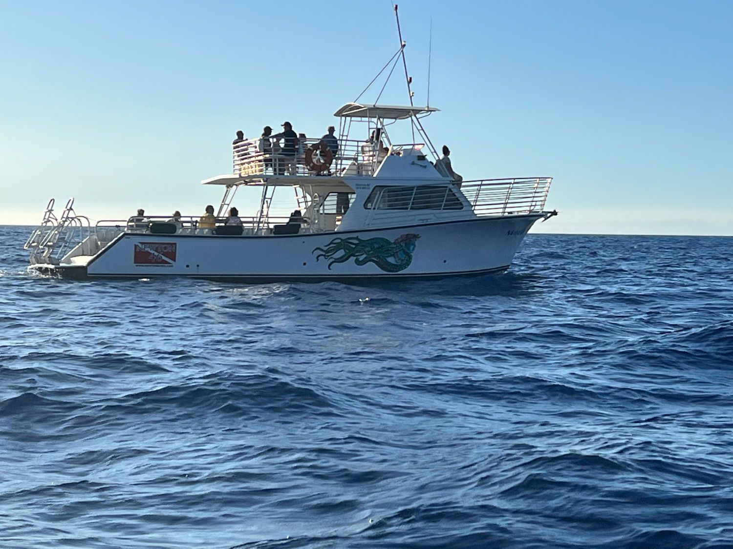 A boat is floating on top of a large body of water.