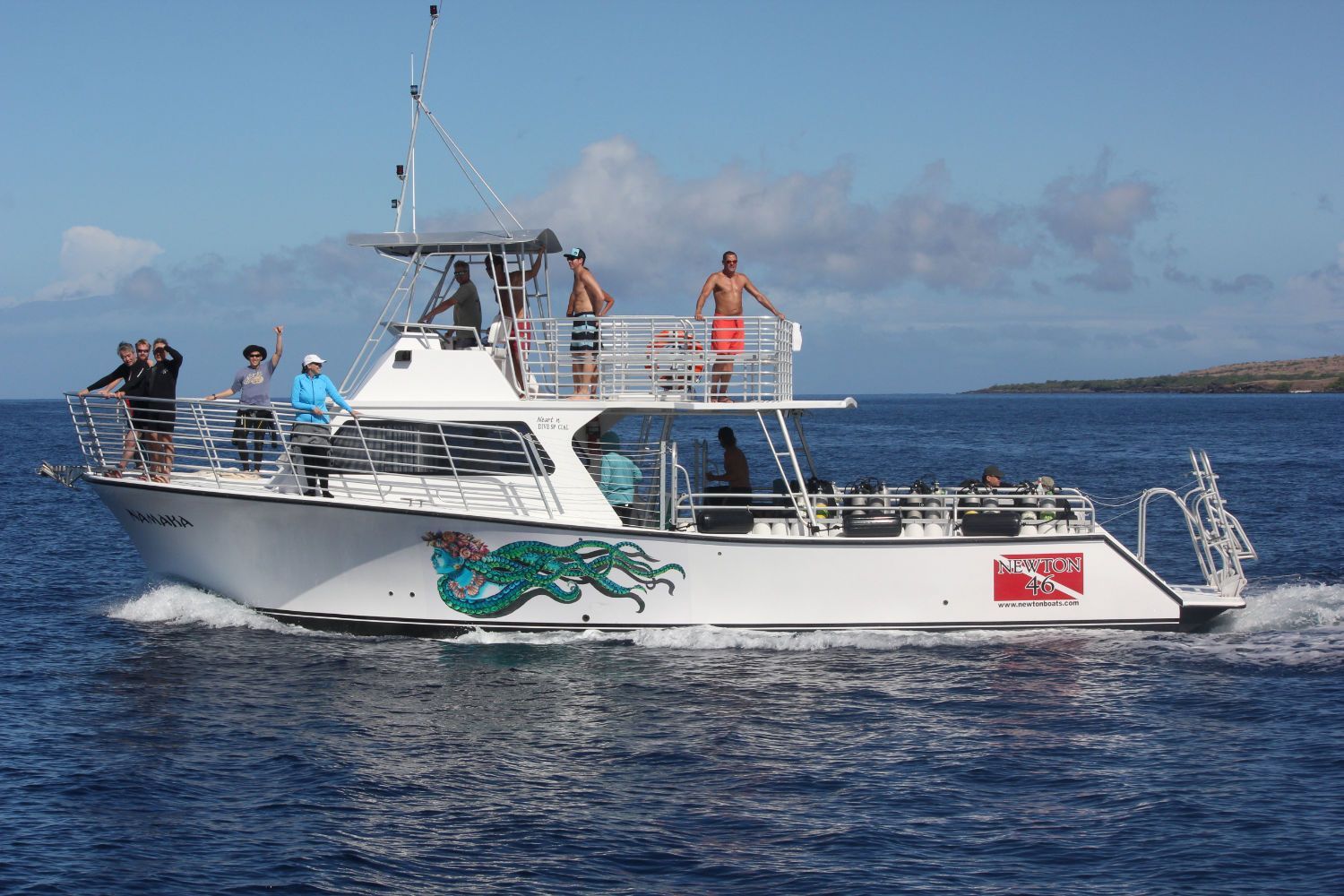 A large white boat is floating on top of a body of water.