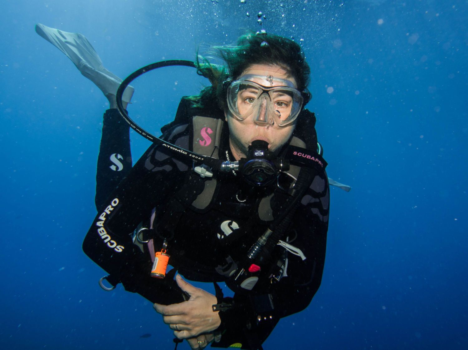 A scubapro scuba diver is swimming in the ocean