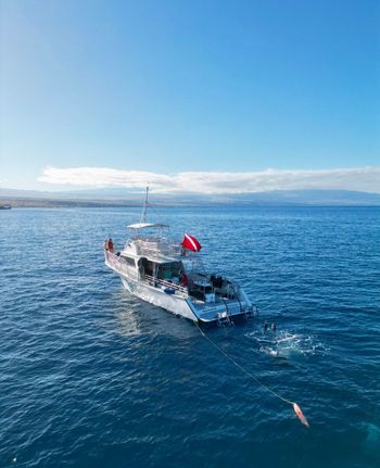 A boat is floating on top of a large body of water.