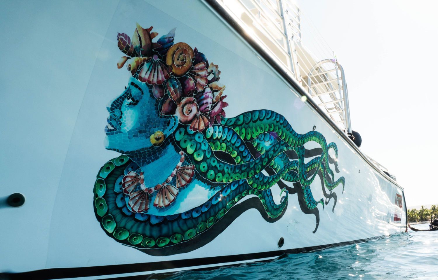 A boat with a painting of a woman and octopus on it