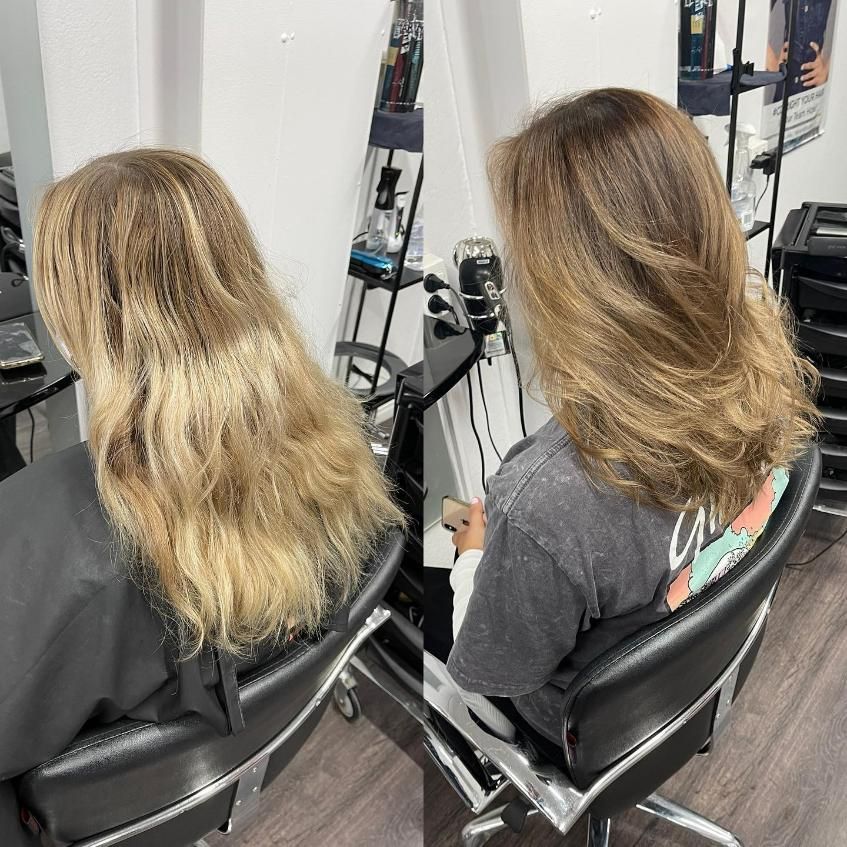 A Woman with Long Blonde Hair Is Sitting in A Chair in A Salon — Main Hair Design in Armidale, NSW