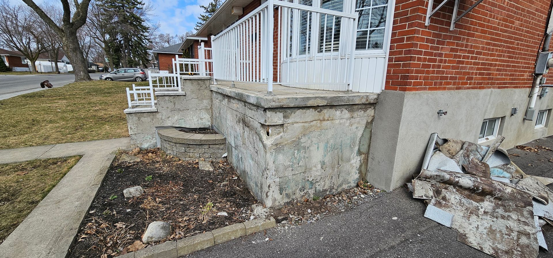 Une maison en brique avec un porche et des escaliers sur le côté.