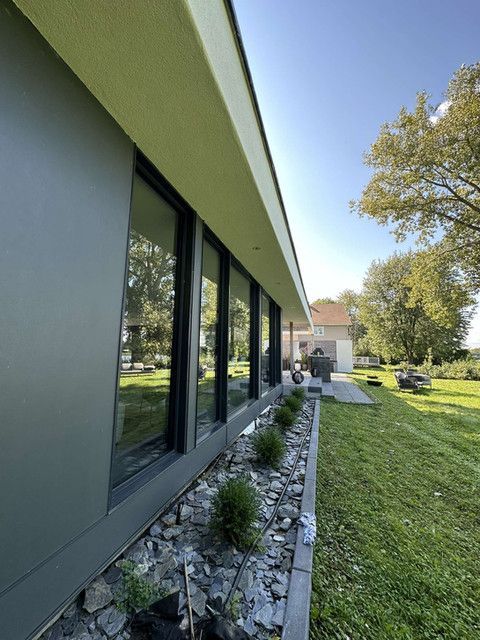 Une maison avec beaucoup de fenêtres sur le côté