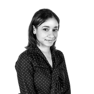 A black and white photo of a woman wearing a polka dot shirt