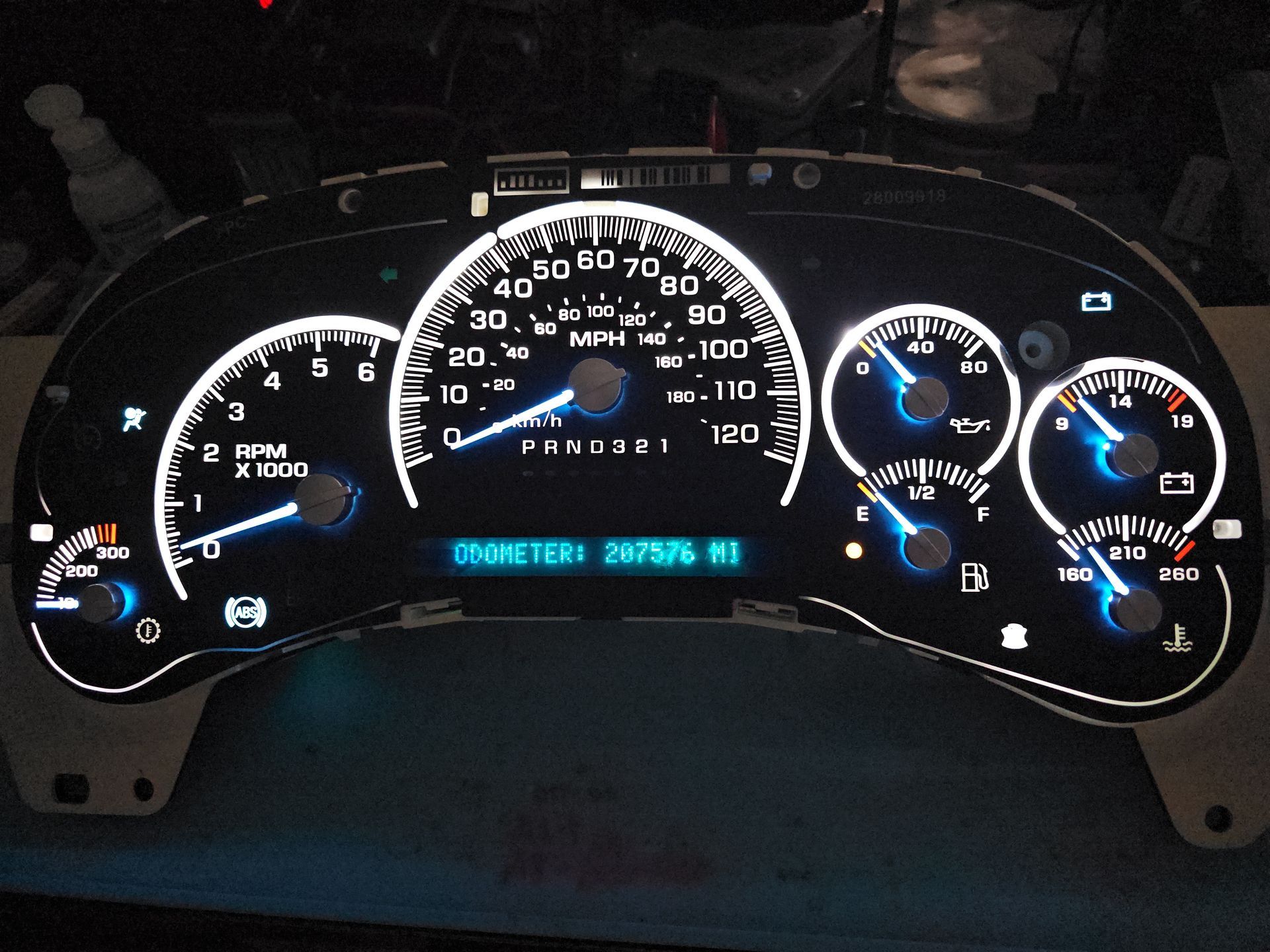 A car dashboard with a digital display that says ' rpm ' on it