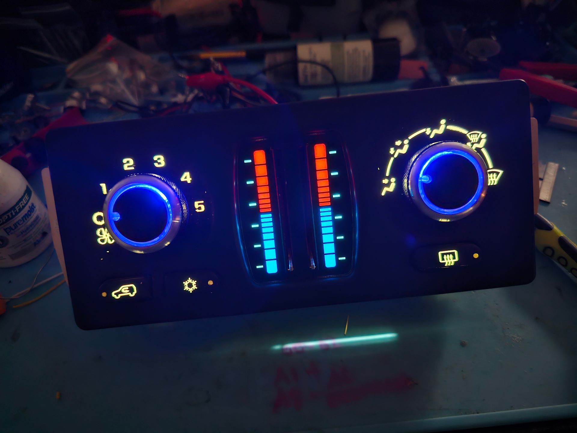 A car climate control panel with blue and red lights