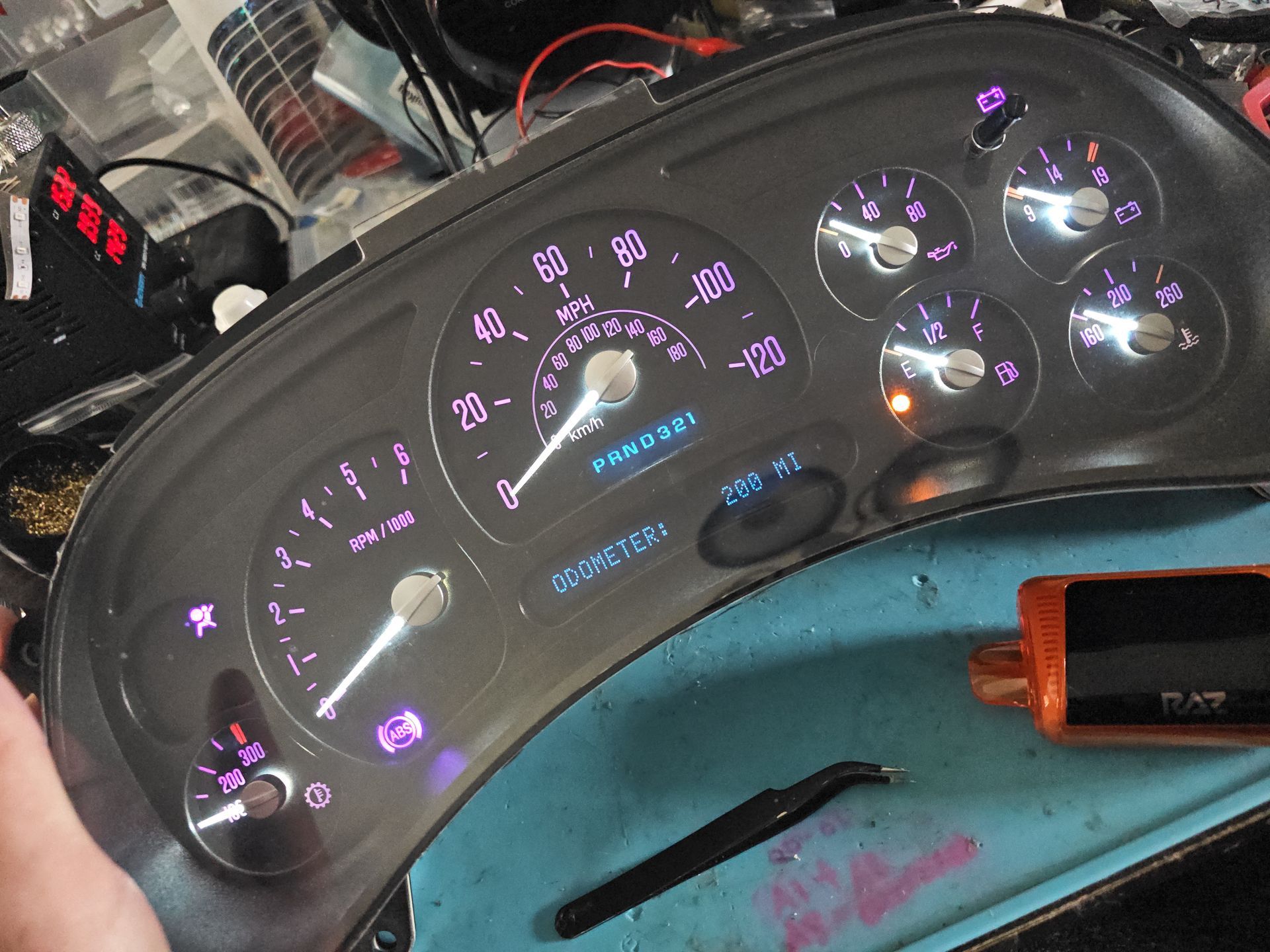 A close up of a car dashboard with purple lights