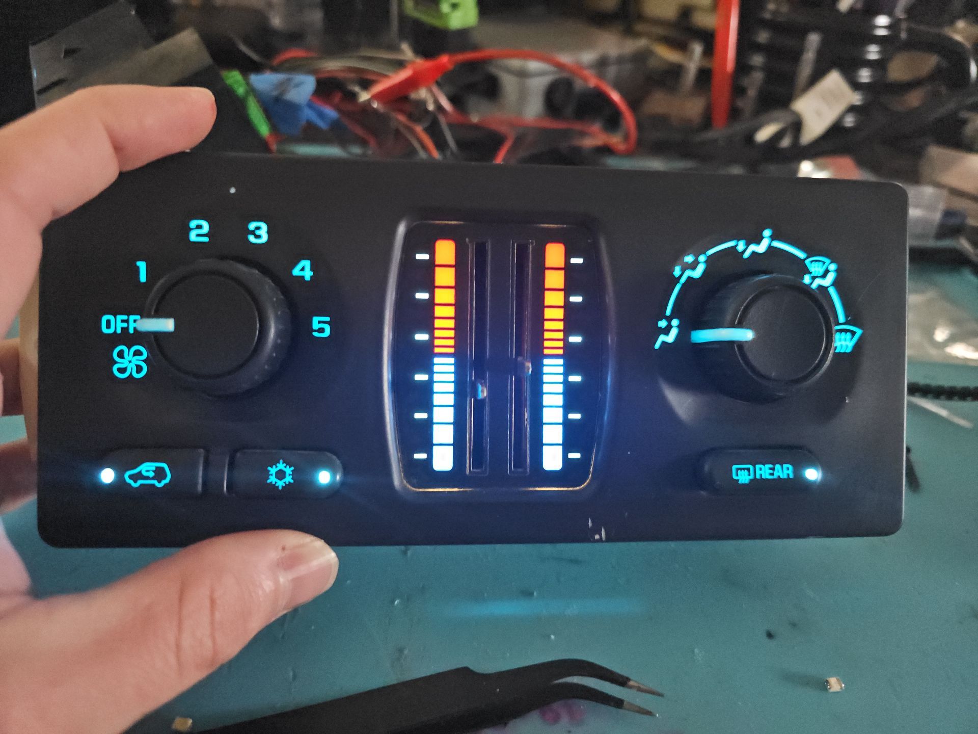 A person is holding a control panel that has the number 2 on it