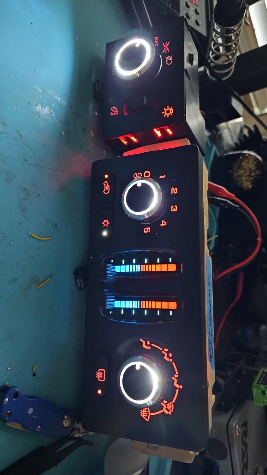 A bunch of buttons are sitting on top of each other on a table.