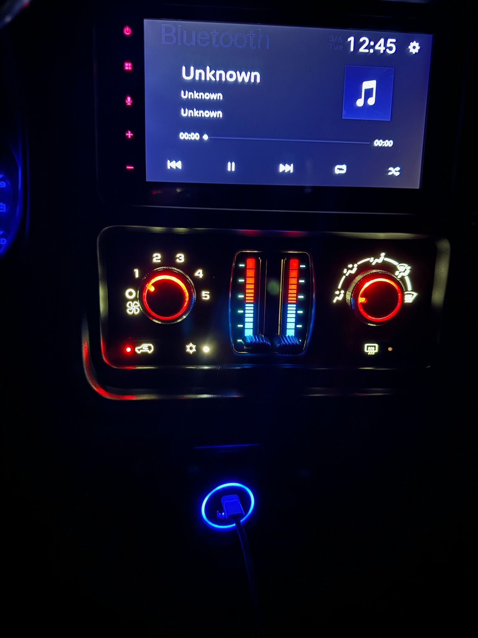A car dashboard with a screen that says unknown on it