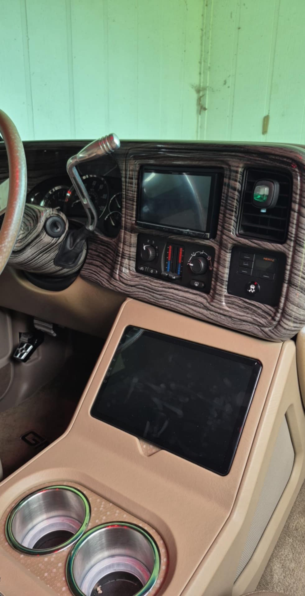 The interior of a car with a steering wheel and a dashboard.