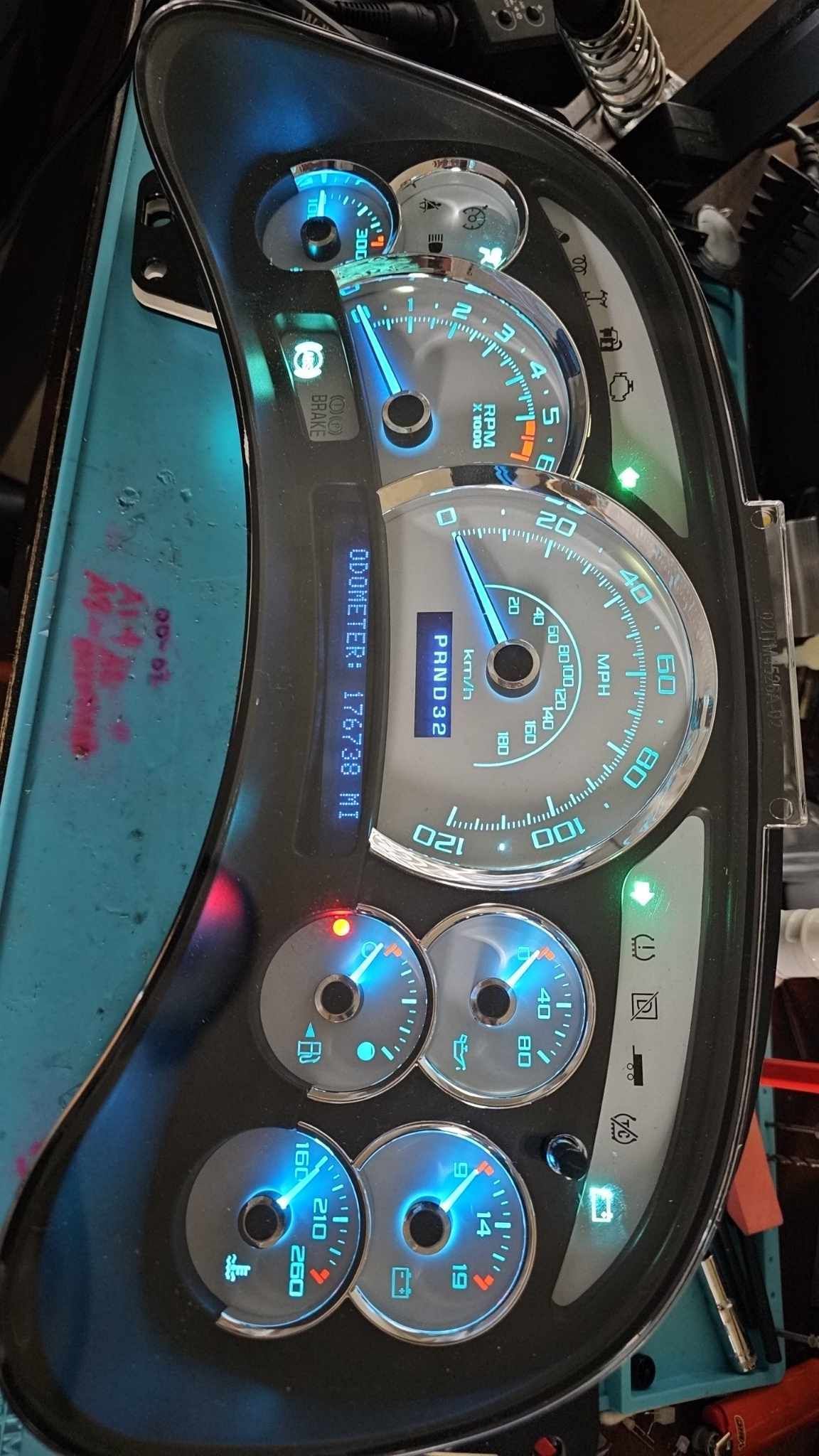 A car dashboard with a lot of gauges and lights on it.
