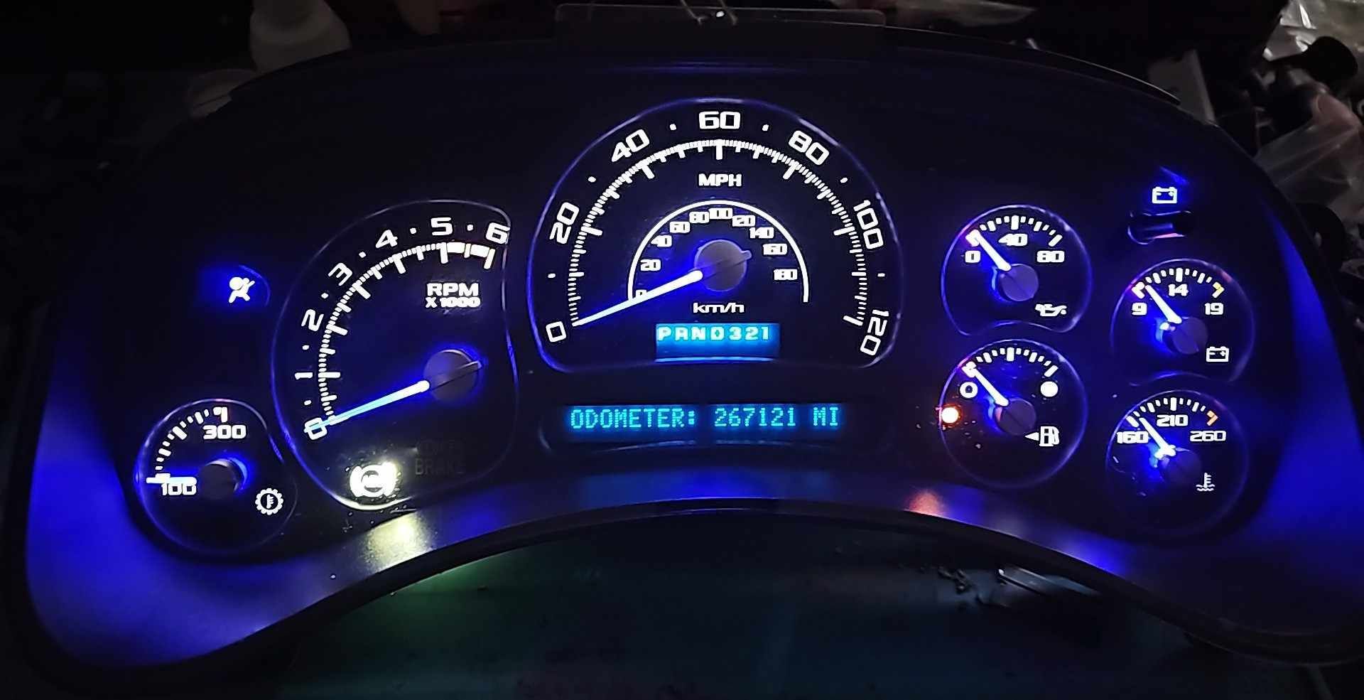A close up of a car dashboard with blue lights on it