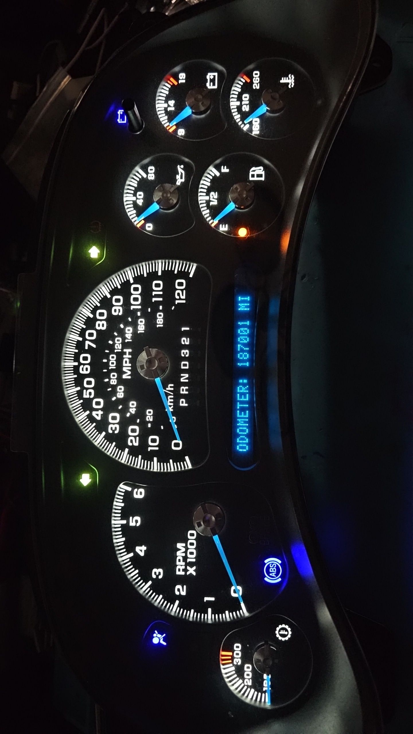 A close up of a car dashboard with a speedometer that reads 30 miles per hour