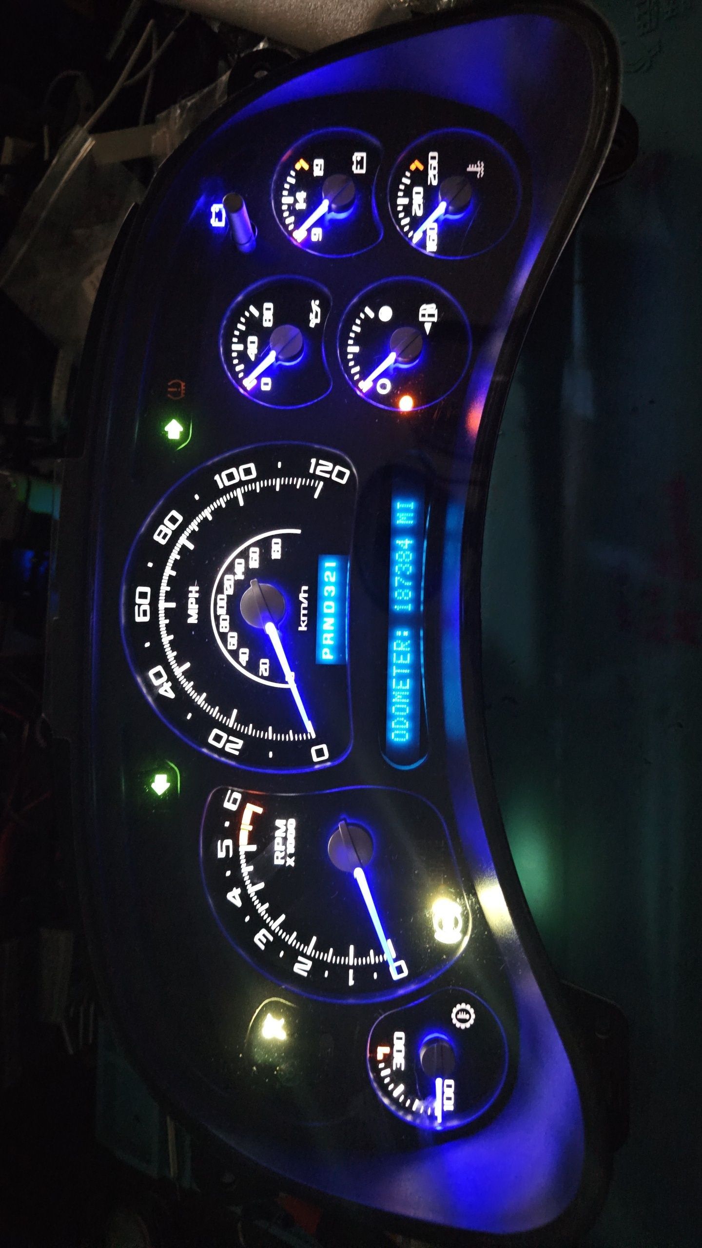 A close up of a car dashboard with blue lights