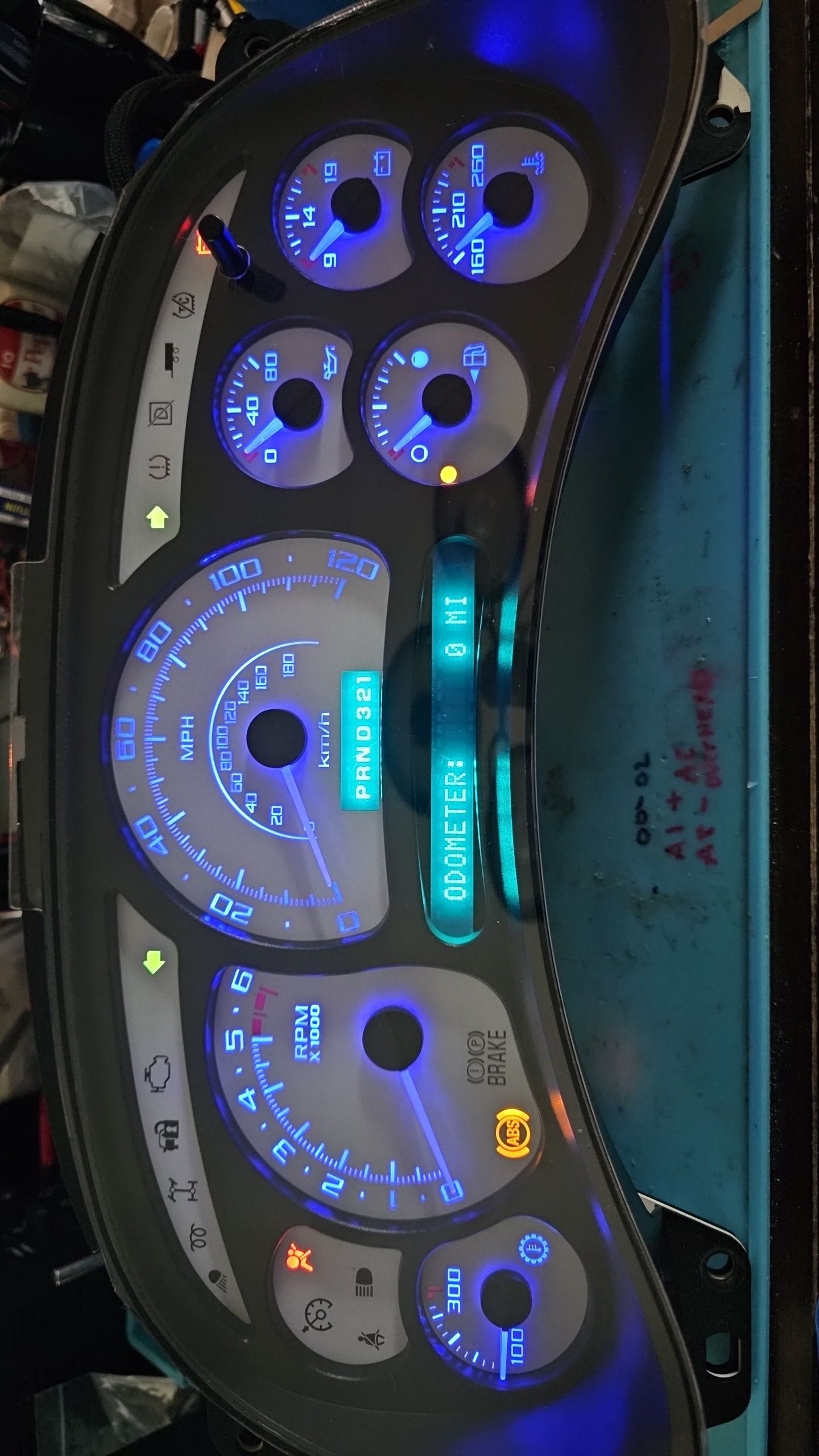 A close up of a car dashboard with blue lights on it.