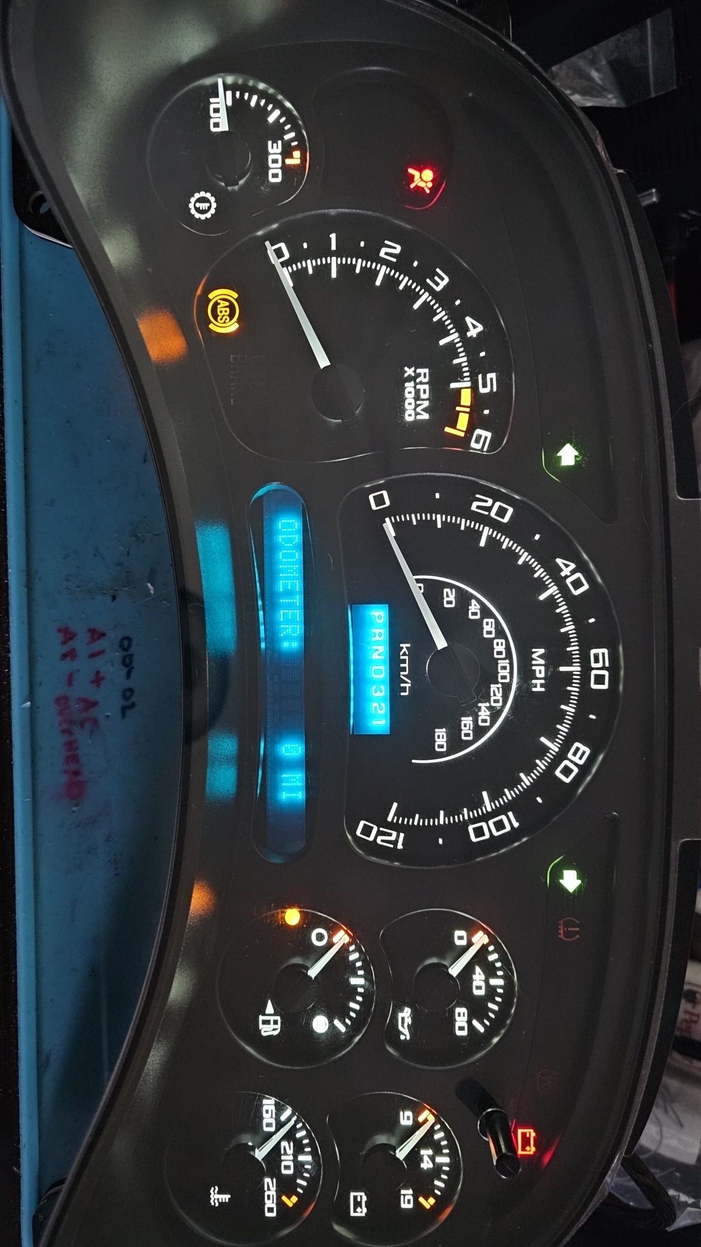 A close up of a dashboard with a speedometer and a fuel gauge