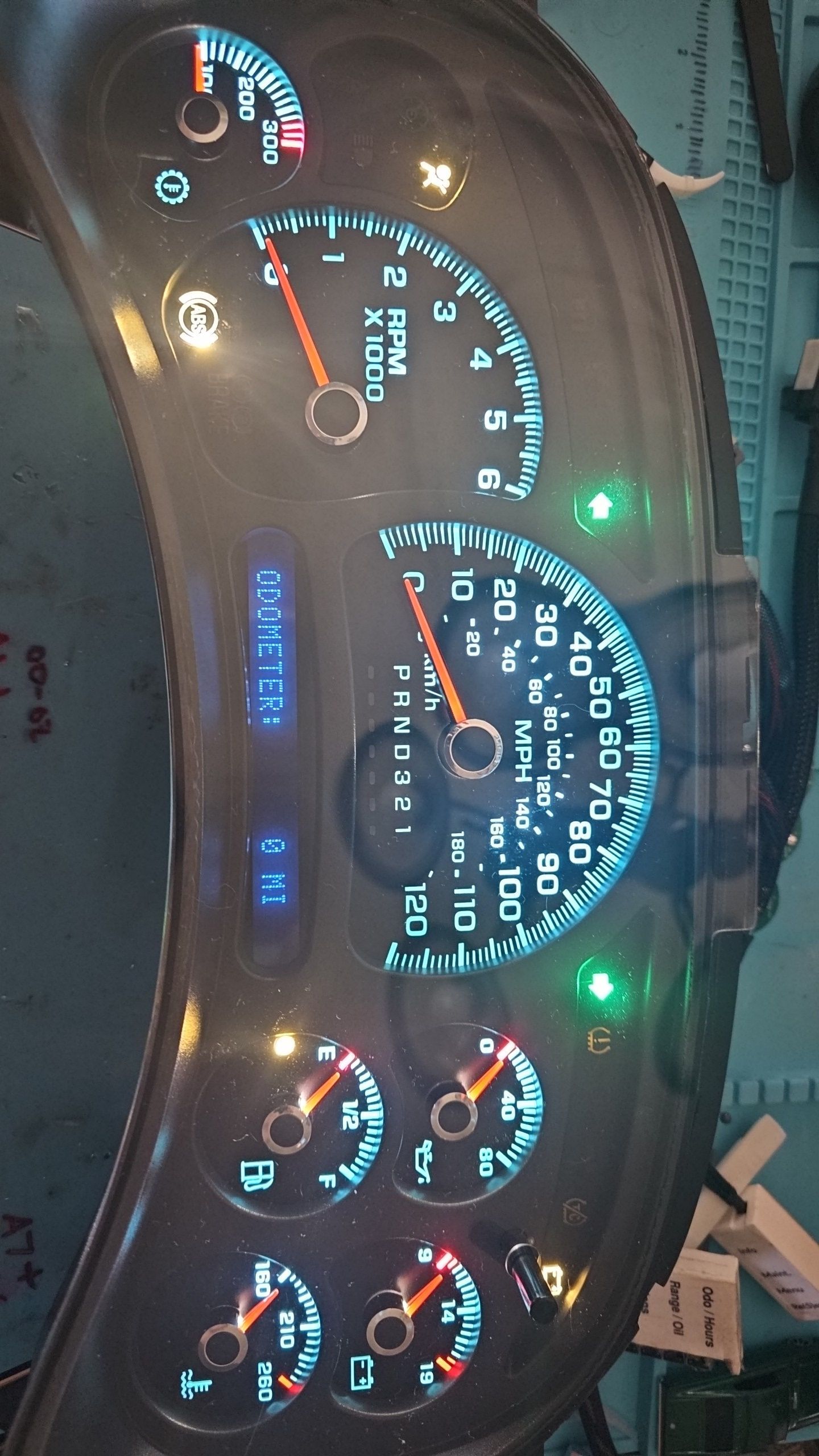 A close up of a car dashboard with a tachometer that says ' rpm ' on it