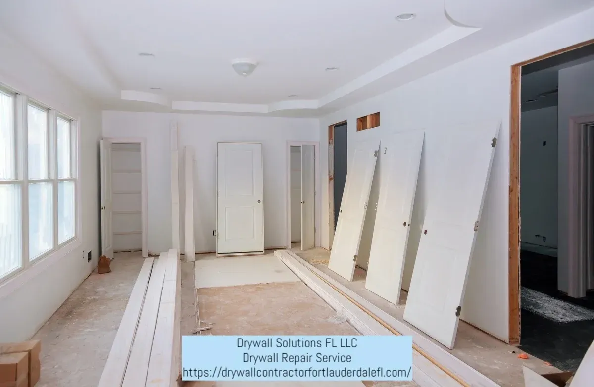 A room that is being remodeled with lots of doors and windows