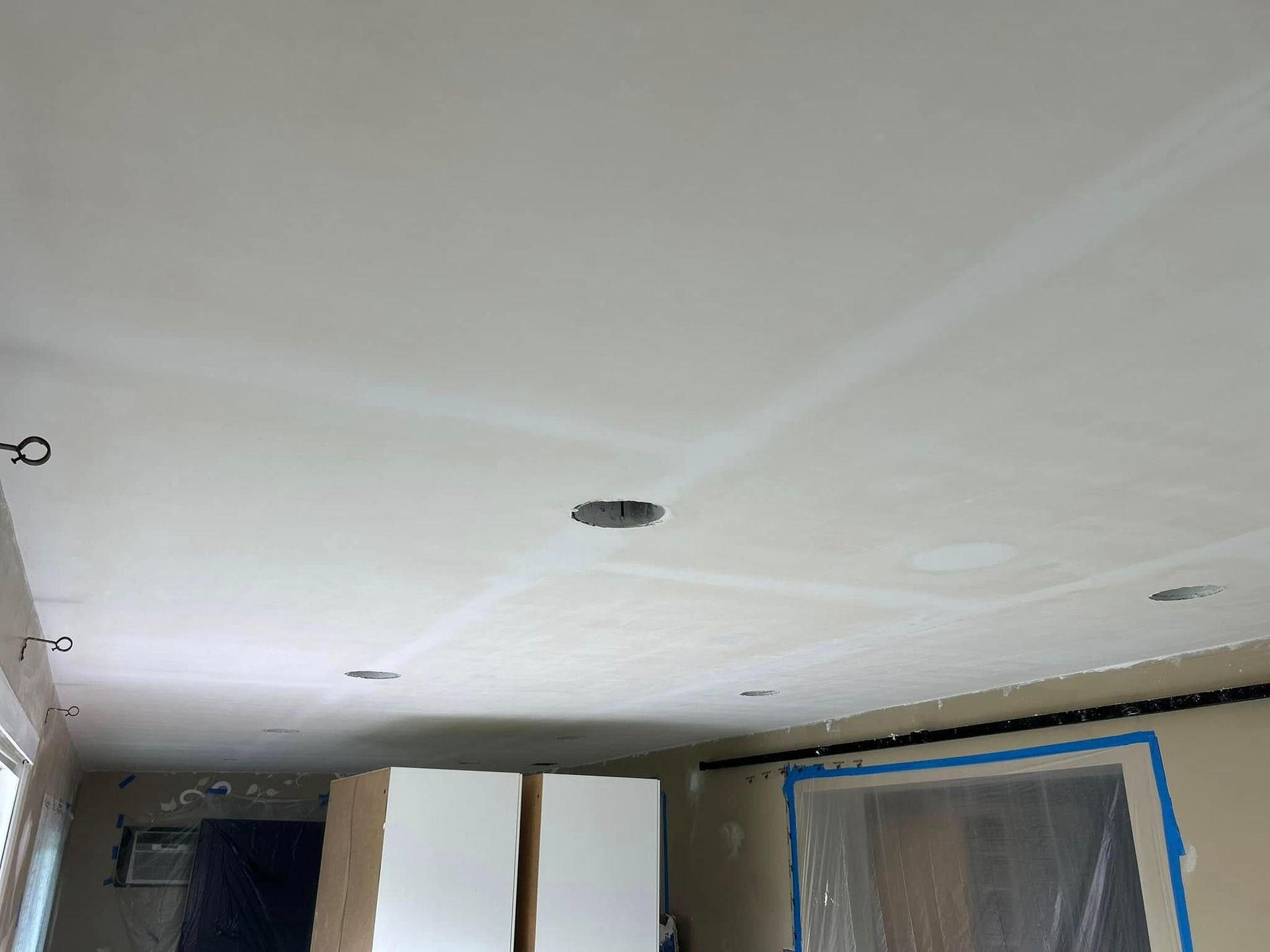 A room with a white ceiling and white cabinets