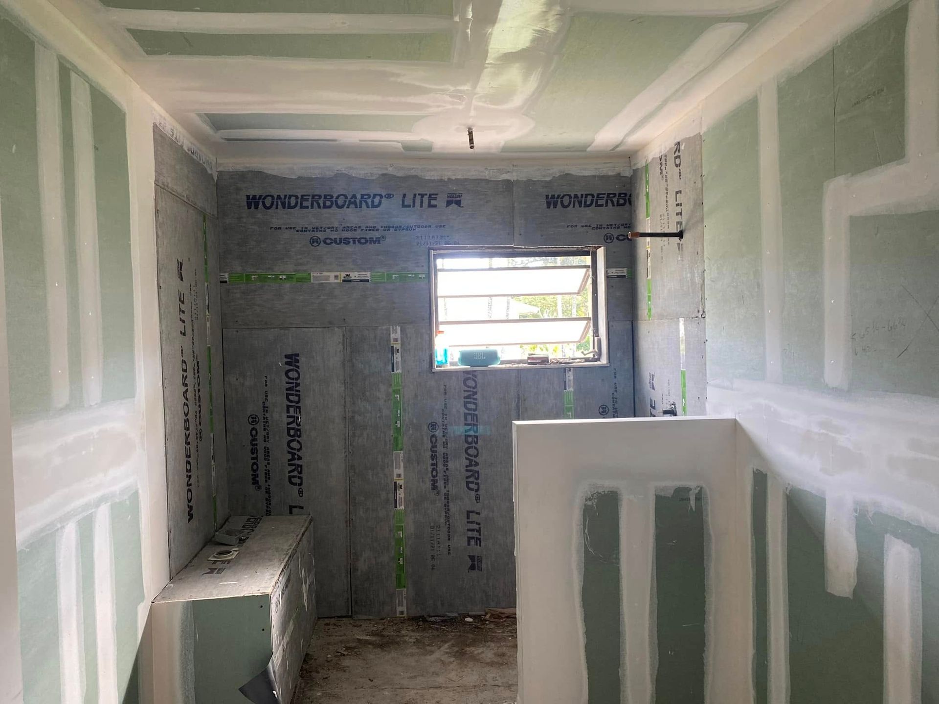 A room that is being remodeled with drywall and a window