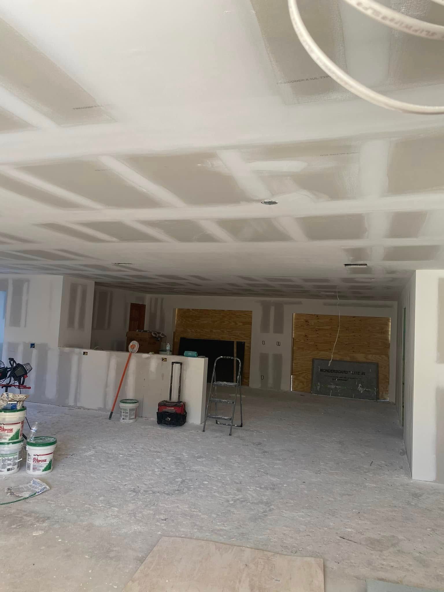 A large room with a ceiling that is being remodeled.