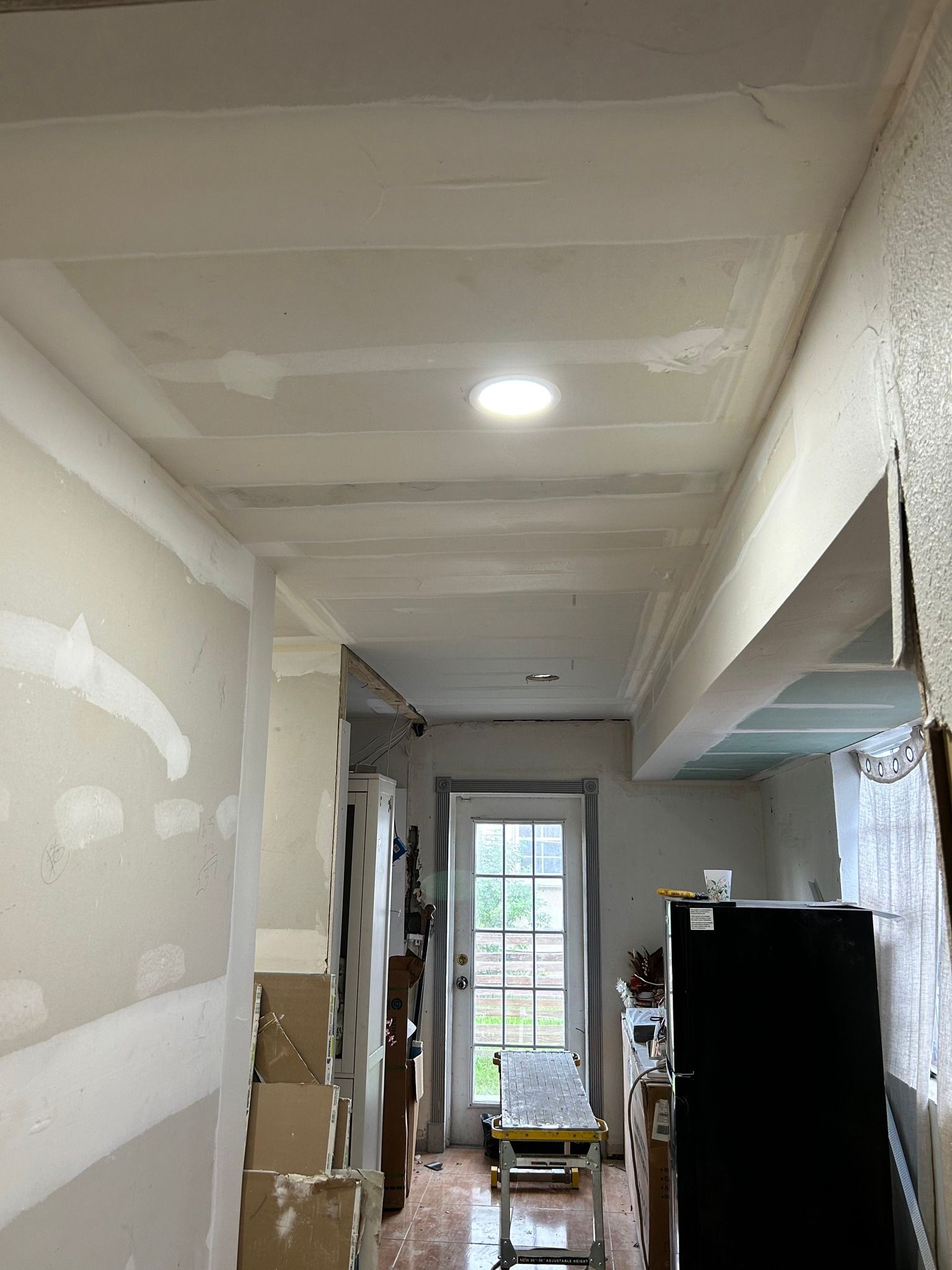 There is a light on the ceiling in the middle of the room.