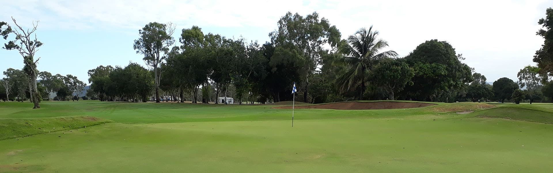A Golf Course With A Green And Trees In The Background — Rowes Bay Golf Club In Rowes Bay, QLD