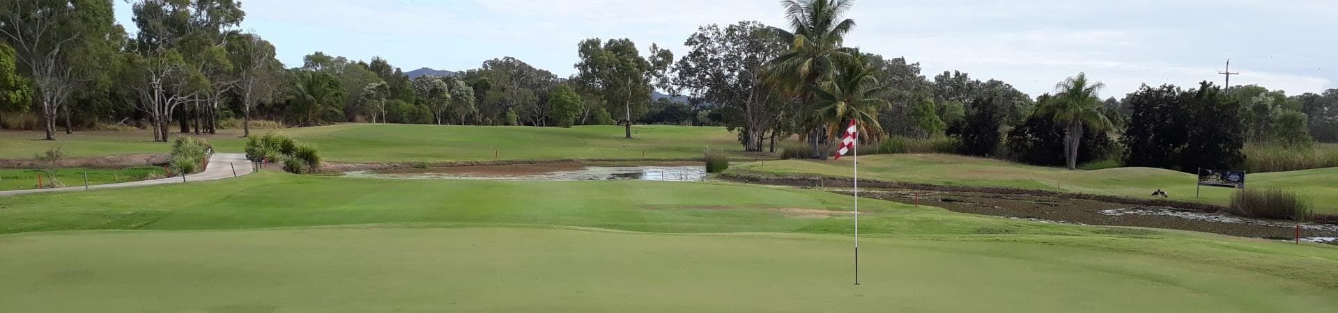 A Golf Course With Trees And A River In The Background — Rowes Bay Golf Club In Rowes Bay, QLD