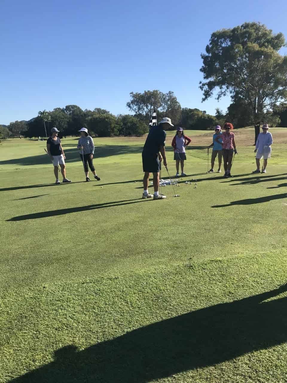 A Group Of People Are Standing On A Golf Course — Rowes Bay Golf Club In Rowes Bay, QLD