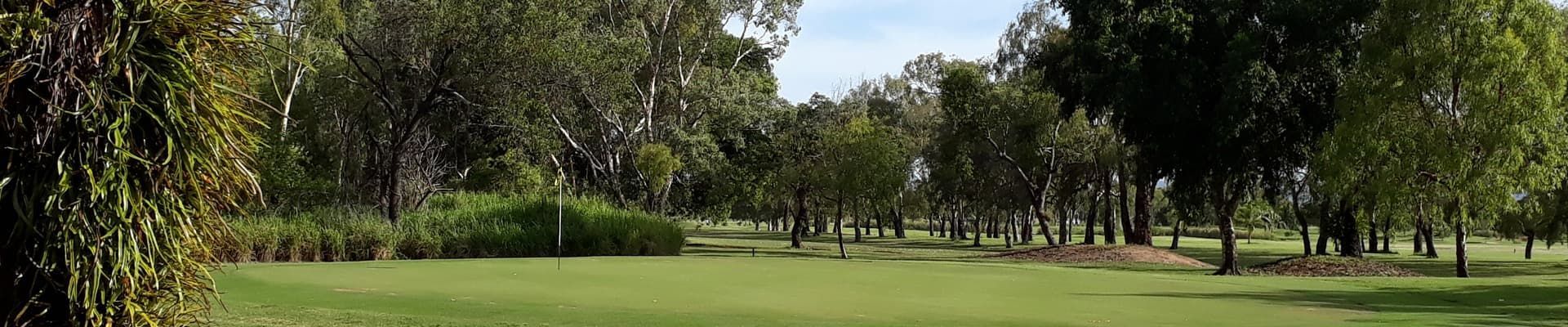 A Lush Green Field Surrounded By Trees On A Sunny Day — Rowes Bay Golf Club In Rowes Bay, QLD