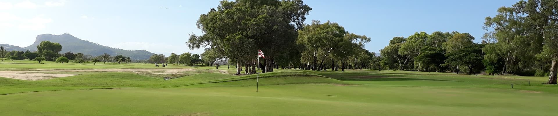 A Blurred Image Of A Golf Course With Trees In The Background — Rowes Bay Golf Club In Rowes Bay, QLD