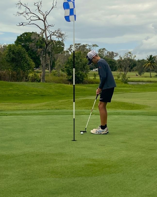 A Man Is Putting A Golf Ball On A Green — Rowes Bay Golf Club In Rowes Bay, QLD