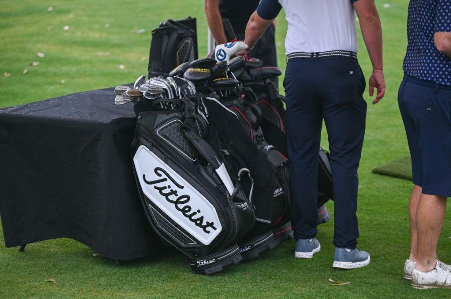A Man Is Standing Next To A Titleist Golf Bag On A Golf Course — Rowes Bay Golf Club In Rowes Bay, QLD