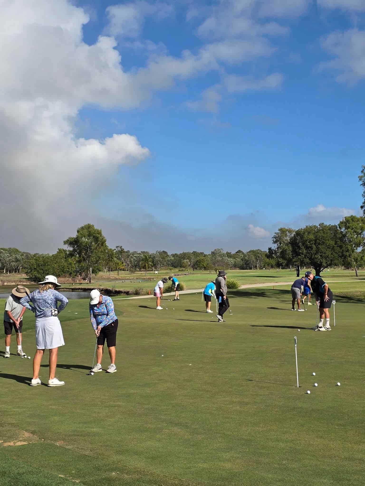 A Group Of People Are Playing Golf On A Lush Green Field — Rowes Bay Golf Club In Rowes Bay, QLD