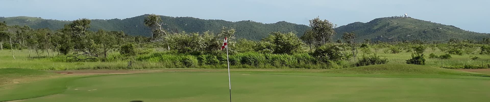 A Golf Course With Mountains In The Background And Trees In The Foreground — Rowes Bay Golf Club In Rowes Bay, QLD