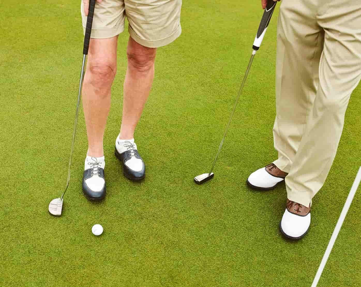 Two Men Are Playing Golf On A Green And One Has A Broken Putter — Rowes Bay Golf Club In Rowes Bay, QLD
