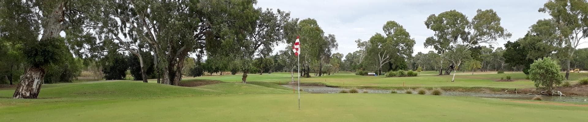 A Golf Course With Trees And A Pond In The Background — Rowes Bay Golf Club In Rowes Bay, QLD