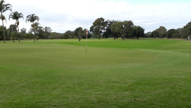 A Golf Course With A Flag In The Middle Of It — Rowes Bay Golf Club In Rowes Bay, QLD