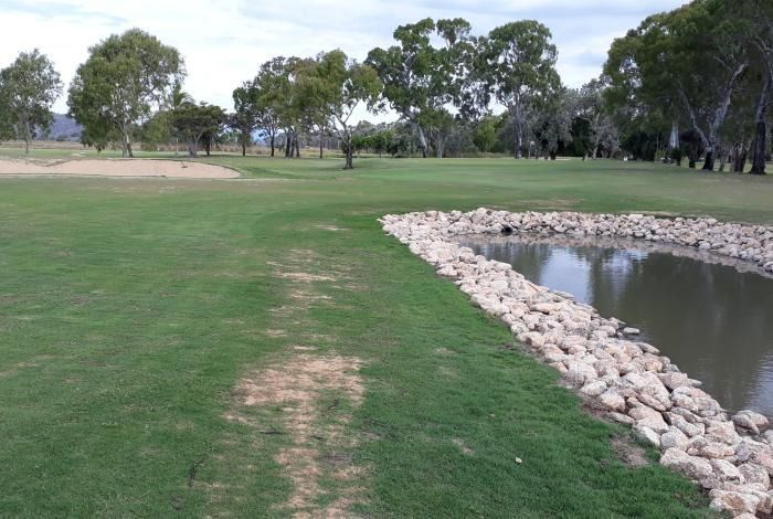 A Golf Course With A Pond In The Middle Of It — Rowes Bay Golf Club In Rowes Bay, QLD