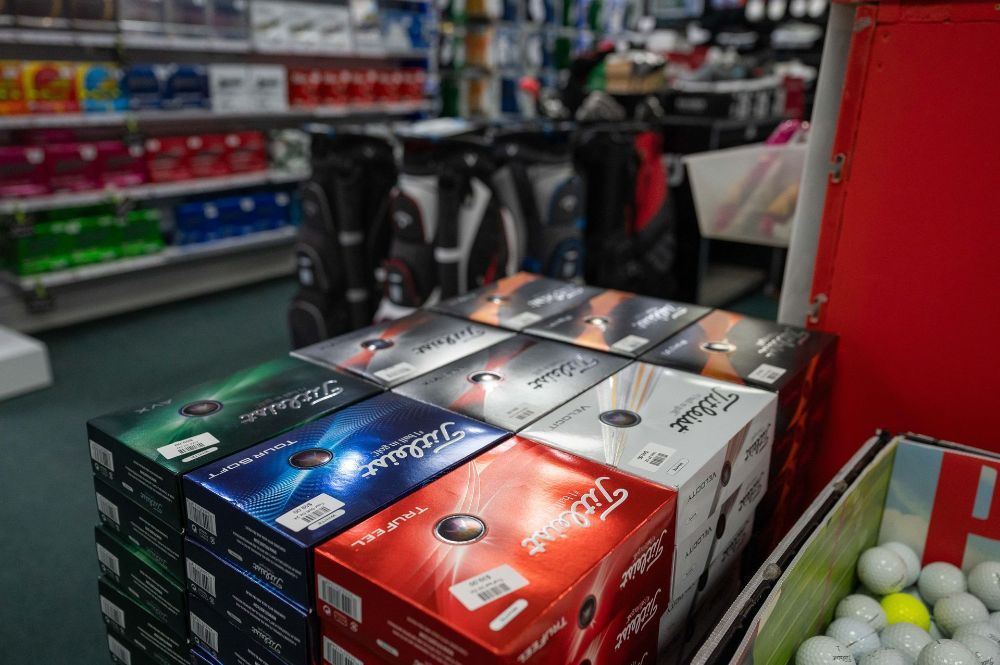 A Pair Of Golf Shoes And A Golf Club On A Golf Course — Rowes Bay Golf Club In Rowes Bay, QLD