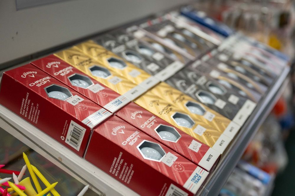 A Person Is Putting A Golf Ball On A Tee — Rowes Bay Golf Club In Rowes Bay, QLD