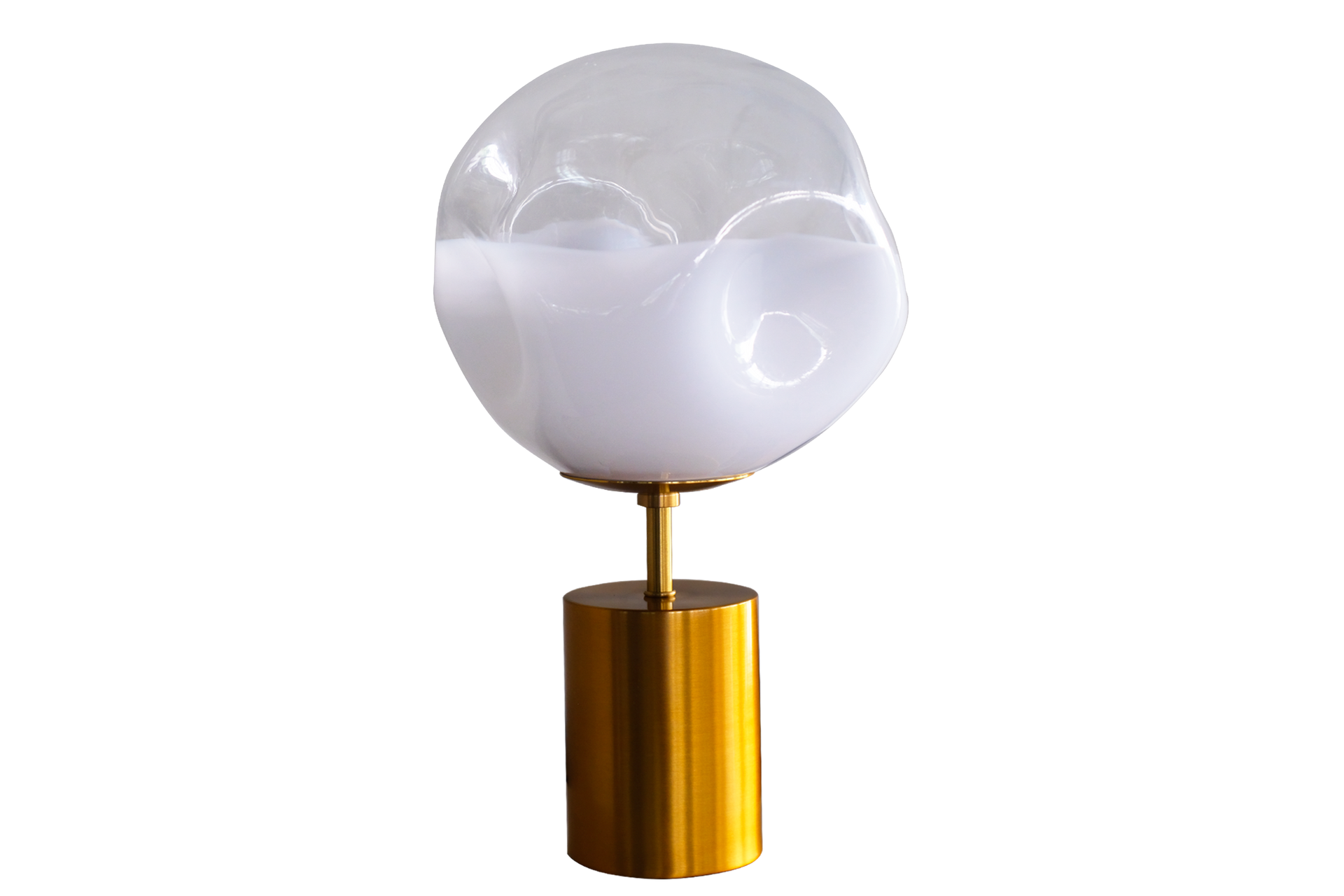 A table lamp with a clear glass globe on a gold base.